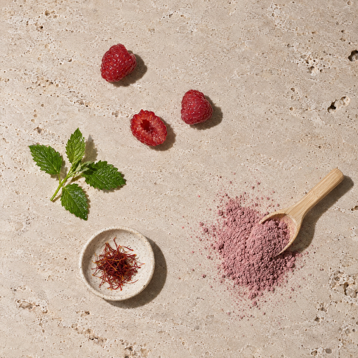 Raspberries, lemon balm, saffron and a scoop of ALORA powder (illustrative image)